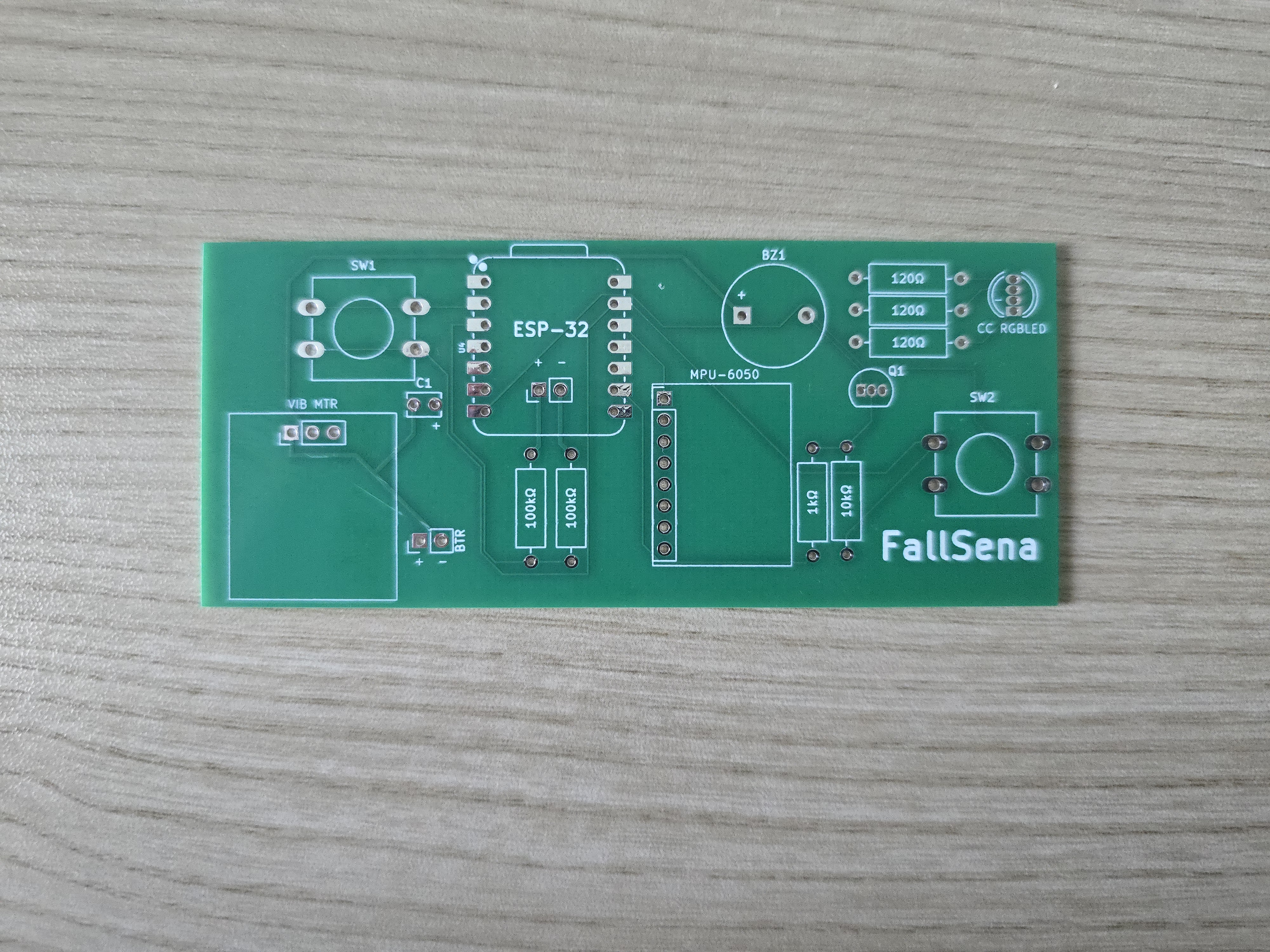 The green FallSena circuit board before any parts were soldered on, with the outline and label of each part printed on it